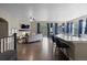 Open-concept living area with a stone fireplace, bar seating and easy access to outdoor space at 1734 Summerglow Ln, Monument, CO 80132