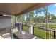 Covered patio with outdoor furniture and views of the trees and landscaping at 1734 Summerglow Ln, Monument, CO 80132