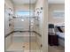 Modern glass shower featuring dual shower heads, bench seating, and sleek design with a view to the bedroom at 1734 Summerglow Ln, Monument, CO 80132