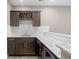 Stylish wet bar features granite countertops, dark cabinetry, wine rack, and beverage refrigerator at 1734 Summerglow Ln, Monument, CO 80132