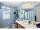 Light blue bathroom with a shower/tub combo and wood vanity at 220 S Julian St # C, Denver, CO 80219