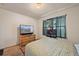 Bedroom with double bed, dresser, TV, and window at 220 S Julian St # C, Denver, CO 80219