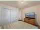 Bedroom with double bed, dresser, TV and double door closet at 220 S Julian St # C, Denver, CO 80219