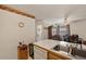 Galley style kitchen with wood cabinets and breakfast bar at 220 S Julian St # C, Denver, CO 80219