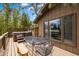 Spacious wooden deck featuring a table with chairs and a hot tub at 24 Ski Pole Ct, Breckenridge, CO 80424
