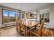 Bright dining room with scenic mountain views, wooden table, bench, and chairs for cozy meals at 24 Ski Pole Ct, Breckenridge, CO 80424