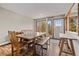 Charming dining room with a wooden table, bench seating, and large windows showcasing beautiful outdoor views at 24 Ski Pole Ct, Breckenridge, CO 80424