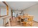 Well-lit dining area with a wooden table, bench, chairs, and view to kitchen, designed for entertaining at 24 Ski Pole Ct, Breckenridge, CO 80424