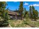 Charming home featuring a large deck, and a well-maintained yard surrounded by mature trees at 24 Ski Pole Ct, Breckenridge, CO 80424