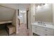 Hallway featuring new vanity, tile floors, and a staircase leading to the upper levels at 24 Ski Pole Ct, Breckenridge, CO 80424