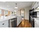 Bright, open kitchen features a stainless dishwasher, island with sink, and light wood floors throughout at 24 Ski Pole Ct, Breckenridge, CO 80424