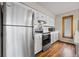 Well-equipped kitchen featuring stainless steel appliances, white cabinets, and wood-look flooring for a modern touch at 24 Ski Pole Ct, Breckenridge, CO 80424