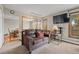 Inviting living room featuring a comfortable leather sofa, flat-screen TV, and natural light, perfect for relaxation at 24 Ski Pole Ct, Breckenridge, CO 80424