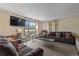 Bright living room features comfortable brown couches and views of the outdoor greenery at 24 Ski Pole Ct, Breckenridge, CO 80424