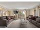 Spacious living room features comfortable brown couches, a TV, and views of the greenery at 24 Ski Pole Ct, Breckenridge, CO 80424