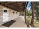 Cozy covered patio with a white door, and a view of the surrounding greenery at 24 Ski Pole Ct, Breckenridge, CO 80424