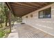 Inviting covered patio perfect for entertaining, with a view of the lush greenery at 24 Ski Pole Ct, Breckenridge, CO 80424