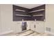 Basement wet bar with open shelving and built in refrigerator at 3576 S Holly St, Denver, CO 80237