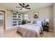 Bedroom with sliding glass doors, modern ceiling fan, and natural light at 3576 S Holly St, Denver, CO 80237