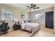 Bright bedroom featuring a ceiling fan, hardwood floors, and a serene window view at 3576 S Holly St, Denver, CO 80237