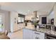 Contemporary kitchen featuring white cabinetry, granite countertops, stainless steel appliances and modern backsplash at 3576 S Holly St, Denver, CO 80237
