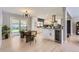 Bright, modern kitchen and dining area with white cabinets, stainless steel appliances, and backyard access at 3576 S Holly St, Denver, CO 80237