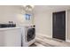 Bright laundry room with updated appliances and laminate flooring at 3576 S Holly St, Denver, CO 80237