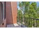 Balcony with wrought iron railing and views of mature trees at 2933 Central Park Blvd, Denver, CO 80238