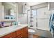 Bright bathroom with a modern vanity, a shower-tub combo, and ample storage at 2933 Central Park Blvd, Denver, CO 80238