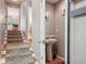 Stylish half bath featuring a modern pedestal sink, decorative mirror, and elegant fixtures at 2933 Central Park Blvd, Denver, CO 80238