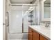 Bright bathroom with a glass shower door, tile surround, and white countertop at 2933 Central Park Blvd, Denver, CO 80238