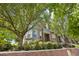 Charming brick townhome with lush greenery, classic architectural details, and a welcoming entrance at 2933 Central Park Blvd, Denver, CO 80238