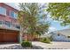 View of a brick home with garages and an upstairs deck at 2933 Central Park Blvd, Denver, CO 80238