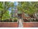 Charming brick townhome featuring lush landscaping and a welcoming entryway with a brick facade at 2933 Central Park Blvd, Denver, CO 80238