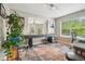 Inviting game room boasts a shuffleboard table, hardwood floors, and abundant natural light at 2933 Central Park Blvd, Denver, CO 80238
