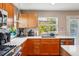 Modern kitchen with stainless steel appliances, granite countertops, backsplash, and a view through the window at 2933 Central Park Blvd, Denver, CO 80238