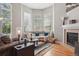 Comfortable living room showcasing hardwood floors, fireplace, and ample natural light at 2933 Central Park Blvd, Denver, CO 80238