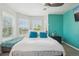 Cozy main bedroom features many windows, a ceiling fan, and an accent wall at 2933 Central Park Blvd, Denver, CO 80238