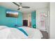Comfortable main bedroom features an accent wall, tv, and access to ensuite bathroom at 2933 Central Park Blvd, Denver, CO 80238