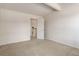 This bedroom features neutral walls and carpet, with a door leading to an ensuite bathroom at 8144 Washington St # 192, Denver, CO 80229