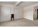 This bedroom offers neutral walls, carpet, two closets, and a dark accent table at 8144 Washington St # 192, Denver, CO 80229