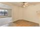 Tile-floored dining area adjacent to the living room, featuring a ceiling fan and breakfast bar at 8144 Washington St # 192, Denver, CO 80229