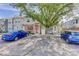 View of townhome exteriors, on-street parking, mature trees, and manicured lawns at 8144 Washington St # 192, Denver, CO 80229