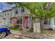 Charming townhome with a welcoming porch, lush tree, brick accents, and parking space at 8144 Washington St # 192, Denver, CO 80229