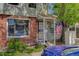 Charming townhome entrance featuring a covered porch, brick accents, and a welcoming American flag at 8144 Washington St # 192, Denver, CO 80229