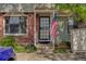 Inviting townhome entrance with brick accents and charming covered porch, accented with American flag at 8144 Washington St # 192, Denver, CO 80229