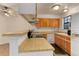 Functional kitchen with light wood countertops and cabinetry, featuring a range hood and updated appliances at 8144 Washington St # 192, Denver, CO 80229