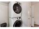 Efficient laundry room with stacked washer and dryer units at 8144 Washington St # 192, Denver, CO 80229