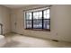 Cozy living room showcasing a large bay window, neutral carpeting, and a bright, inviting space at 8144 Washington St # 192, Denver, CO 80229