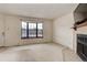 Comfortable living room boasts a large bay window, fireplace, and neutral carpeting at 8144 Washington St # 192, Denver, CO 80229